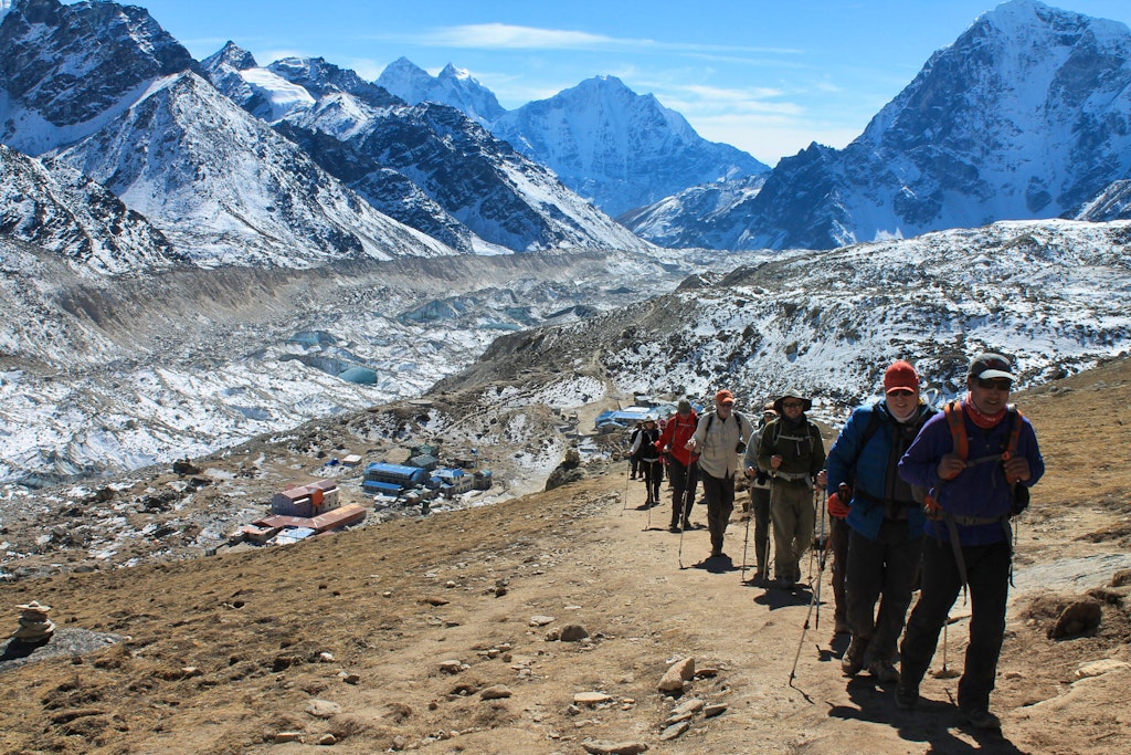 group of hikers guy and girl on a guided trek en route to Everest Base Camp in Nepal 