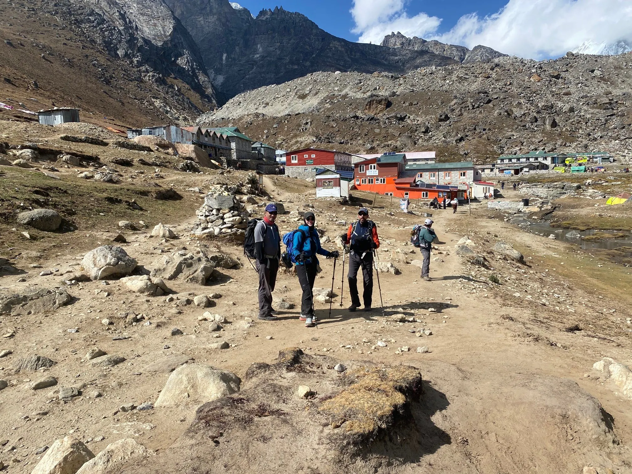 Group of hikers with trekking poles on challenging trek to Everest Base Camp stops near Gorak Shep