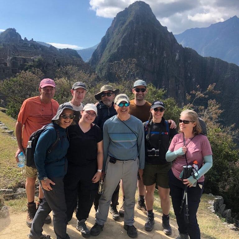 happy travelers in a guided tour on a hiking trail leading to Machu Picchu in Peru