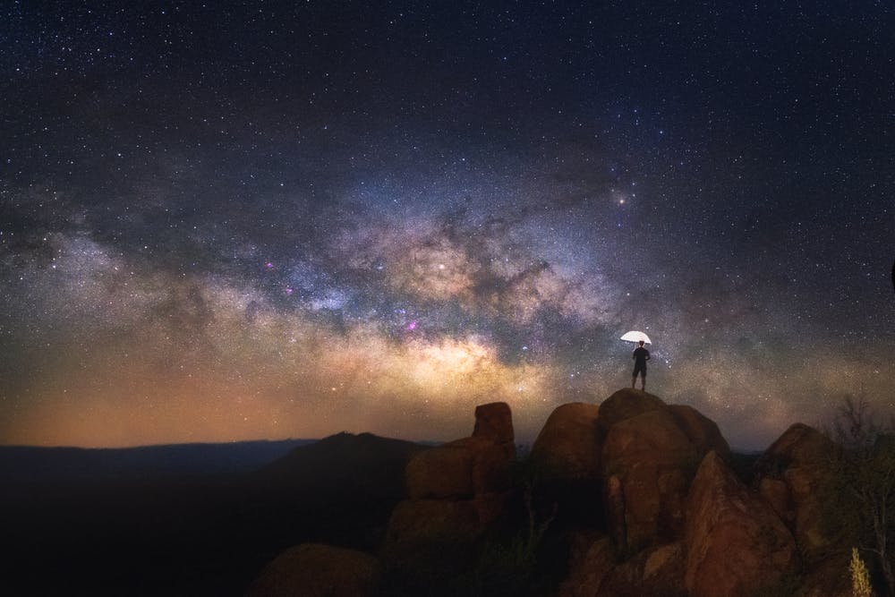 Male traveler star gazing in darkest skies in Big Bend National Park, Texas