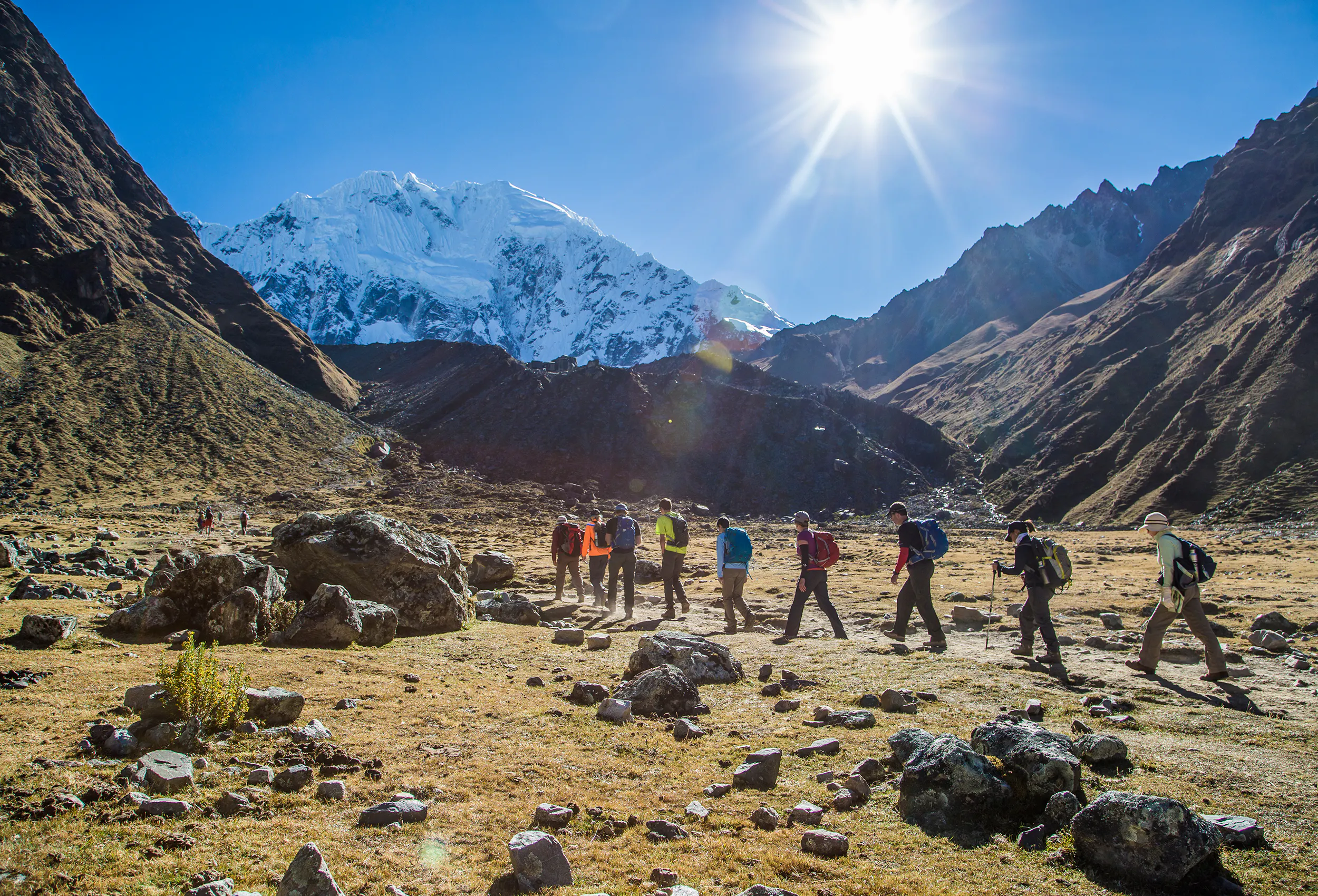 Group of experienced hikers walking trail leading to Machu Picchu near the mountain lodges