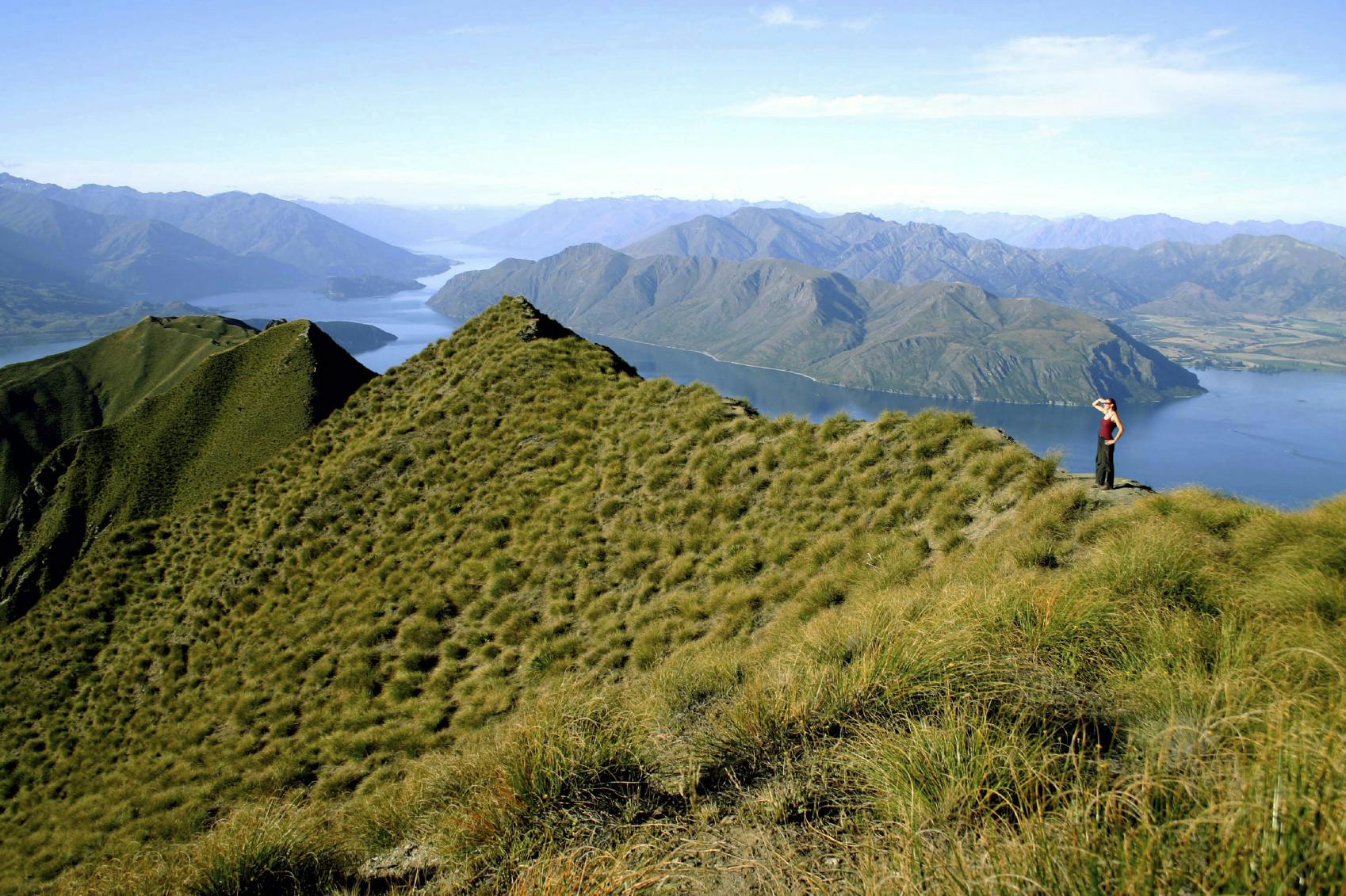 female solo hiker observing something in distance in Lake Wanaka of South Island in New Zealand, Europe