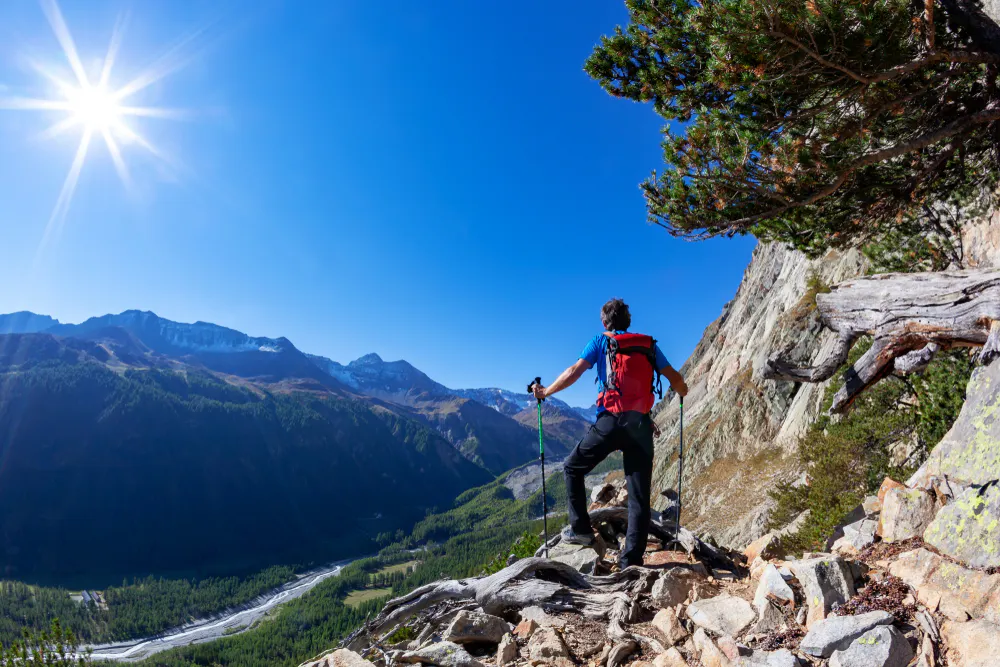 tall solo male traveler embarking on challenging trek that traverses the Graian Alps, a crossroads between Italy and France in Gran Paradiso National Park in Europe