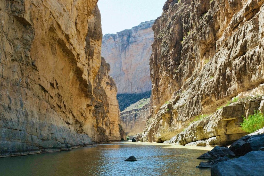 river between rocky mountains under clear sky in Santa Elena Canyon hiking trail in Big Bend National Park