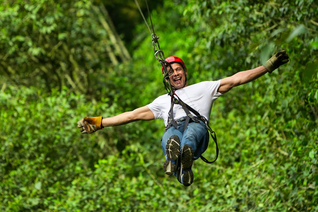 guy zip lining near Pacuare River in Tortuguero National Park in Costa Rica, South America