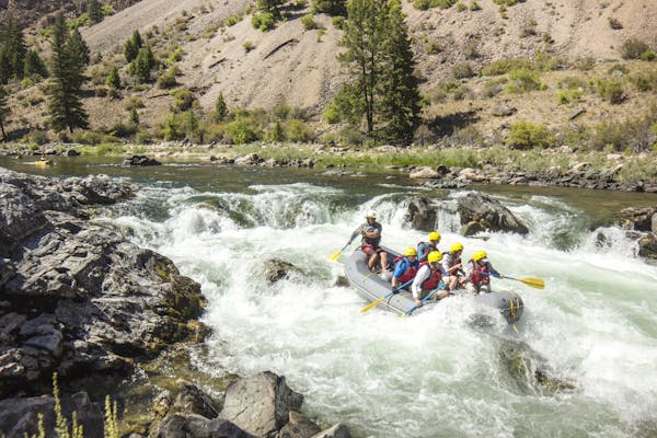 group of rafters rafting whitewater rapids at Middle Fork of the Salmon River in the summertime in Idaho, North America