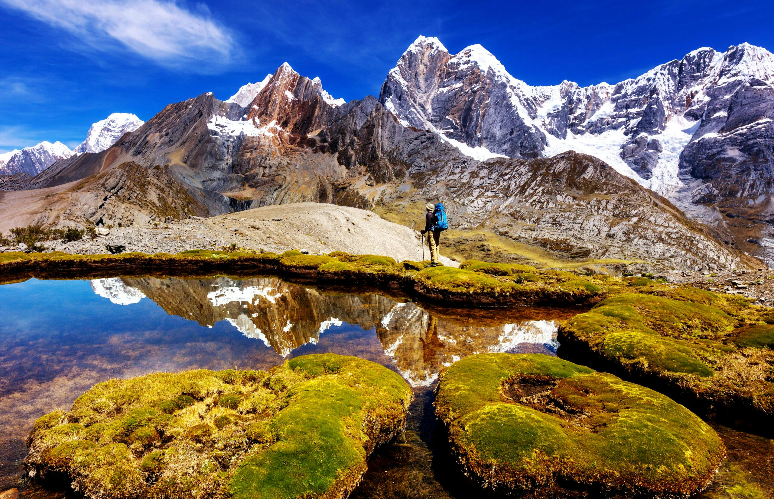 solo male hiker hiking near beautiful mountain landscapes in Cordillera Huayhuash in Peru, South America