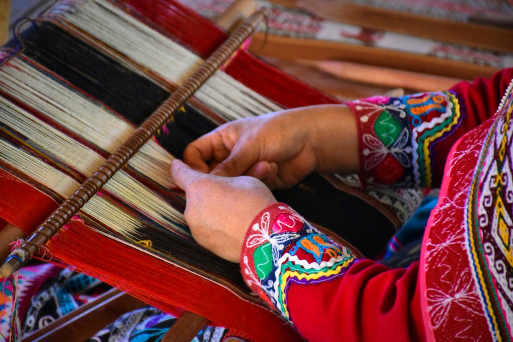 Inca-inspired weaver making robe using colorful yarn in City of Arequipa, Peru, in Latin America