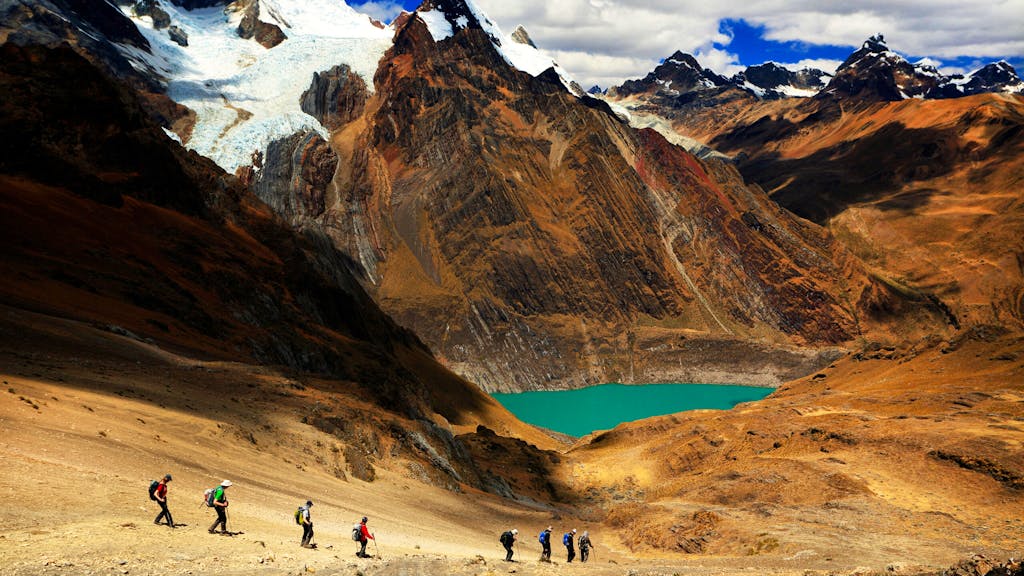 group of trekkers hiking Cordillera Huayhuash in Peru, South America