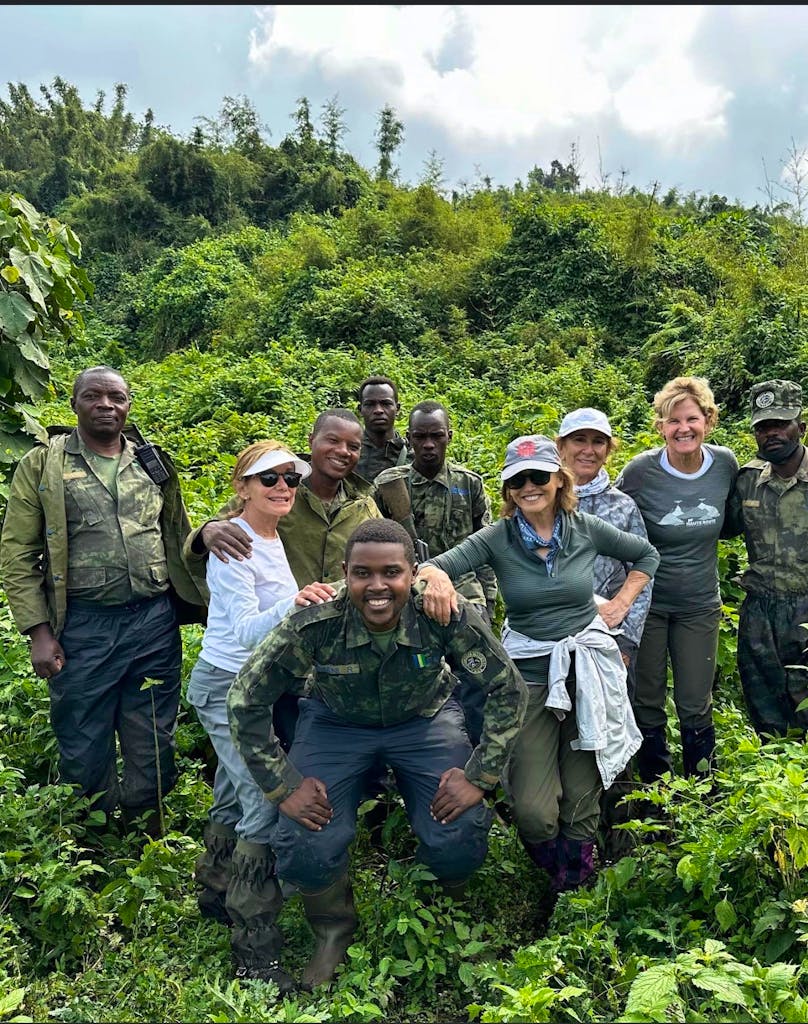 group of female travelers gorilla trekking with expert safari guides in Volcanoes National Park in Rwanda, Africa
