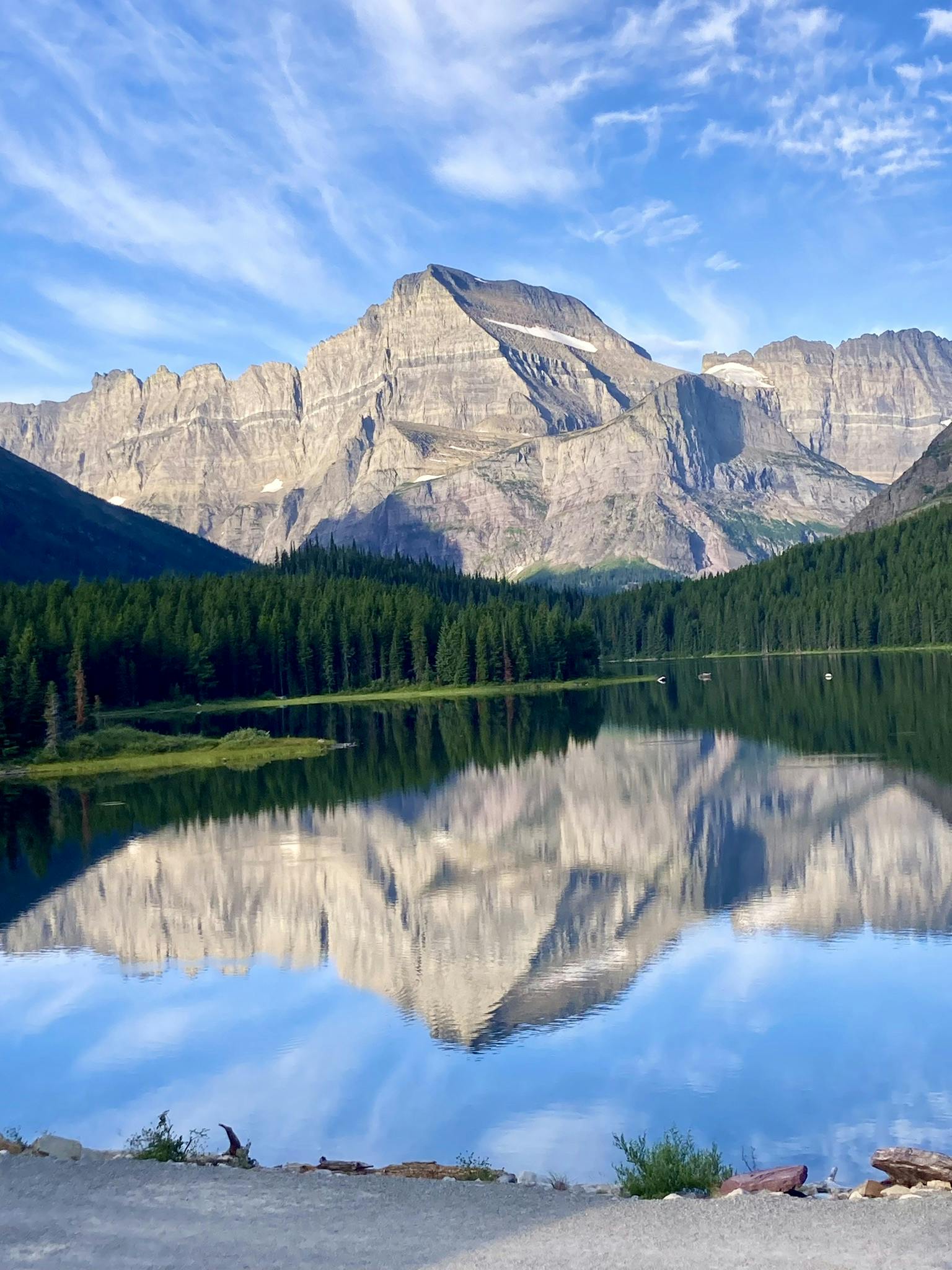 seeing reflection of Glacier National Park lake in Montana, North America