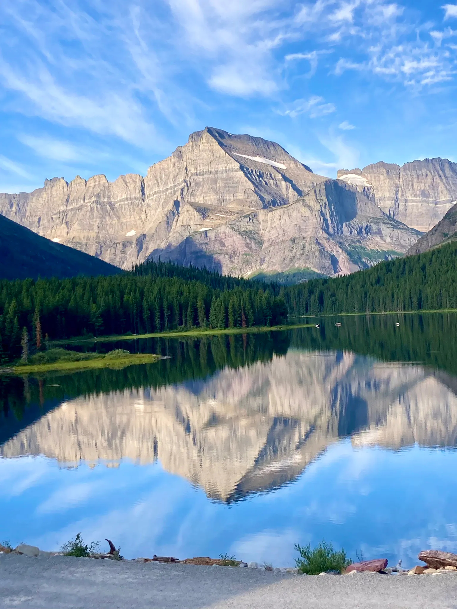 seeing reflection of Glacier National Park lake in Montana, North America