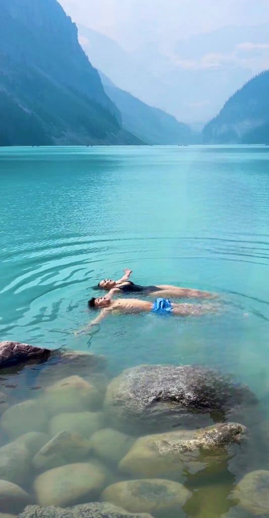 two male and female travelers floating in the Canadian Rockies on a custom adventure in North America