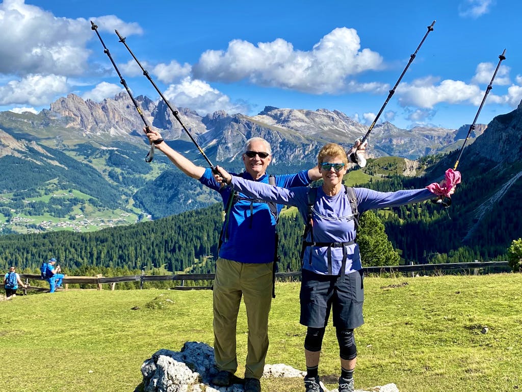 two hikers hiking the Dolomites on a best of Dolomites tour in Alps Region, Europe