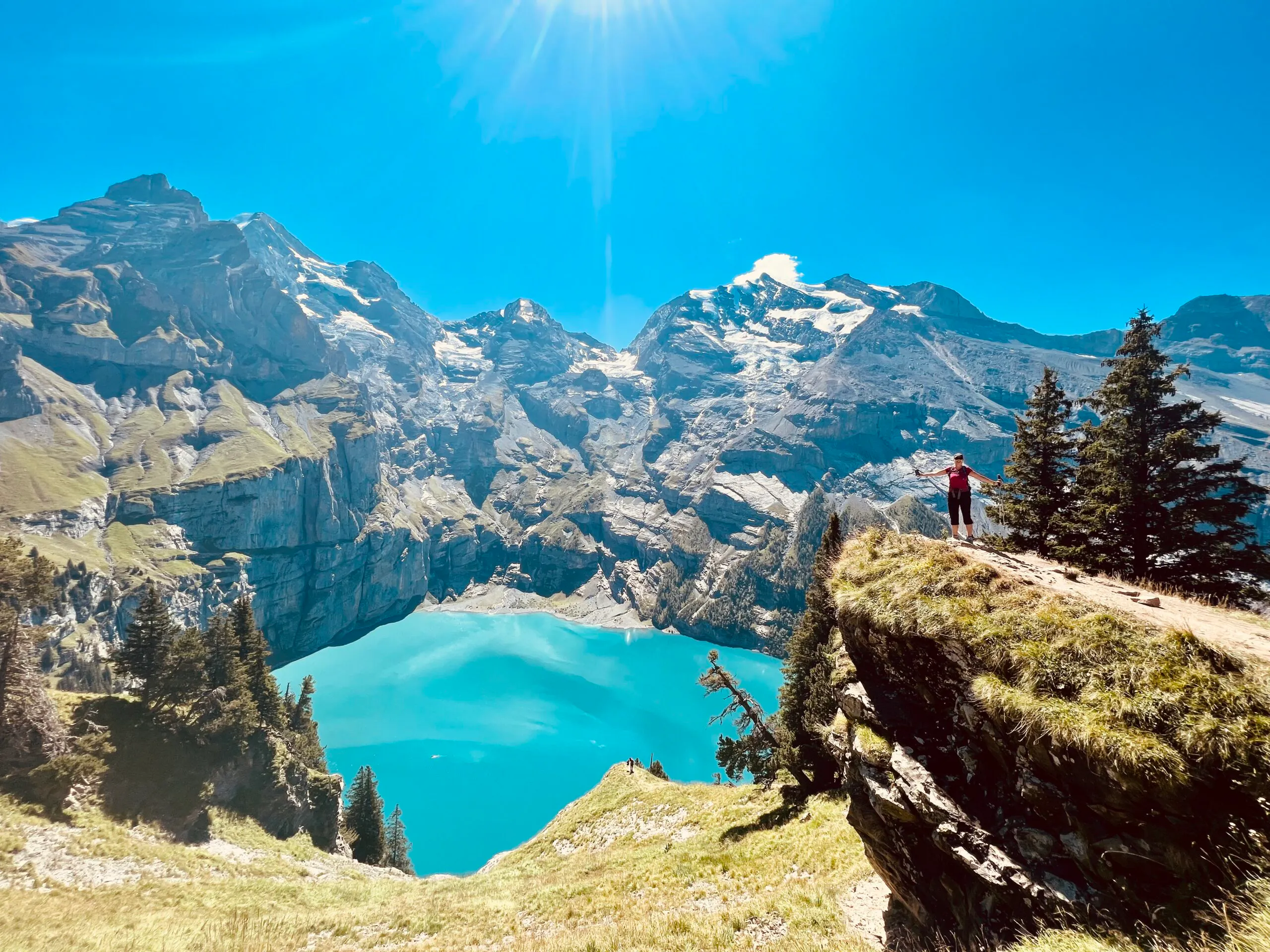 hiking past alpine lakes in series of trails past verdant meadows in ALps region in Europe