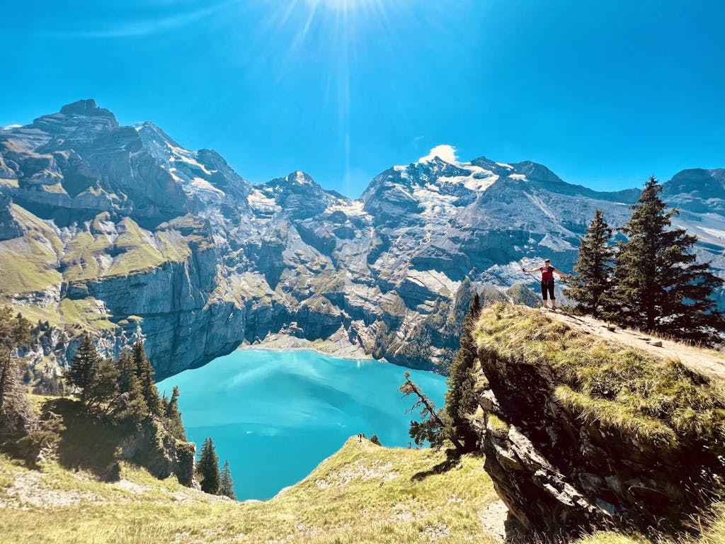hiking past alpine lakes in series of trails past verdant meadows in ALps region in Europe