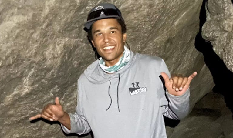 male man in grey hat in a cave exploration 