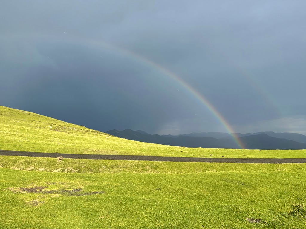 seeing a big rainbow in the middle of a pilgrimage in the Camino de Santiago trail in Spain, Europe