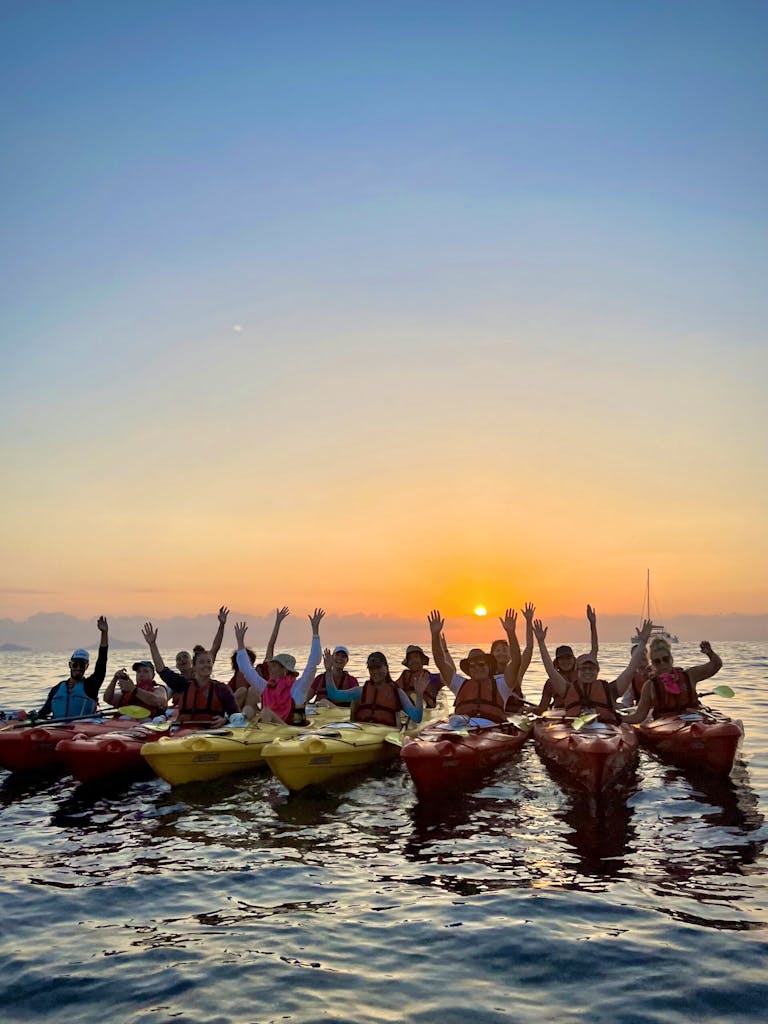 group of travelers kayaking in Aegan Sea near Santorini on a multi-adventure in Greece, Europe