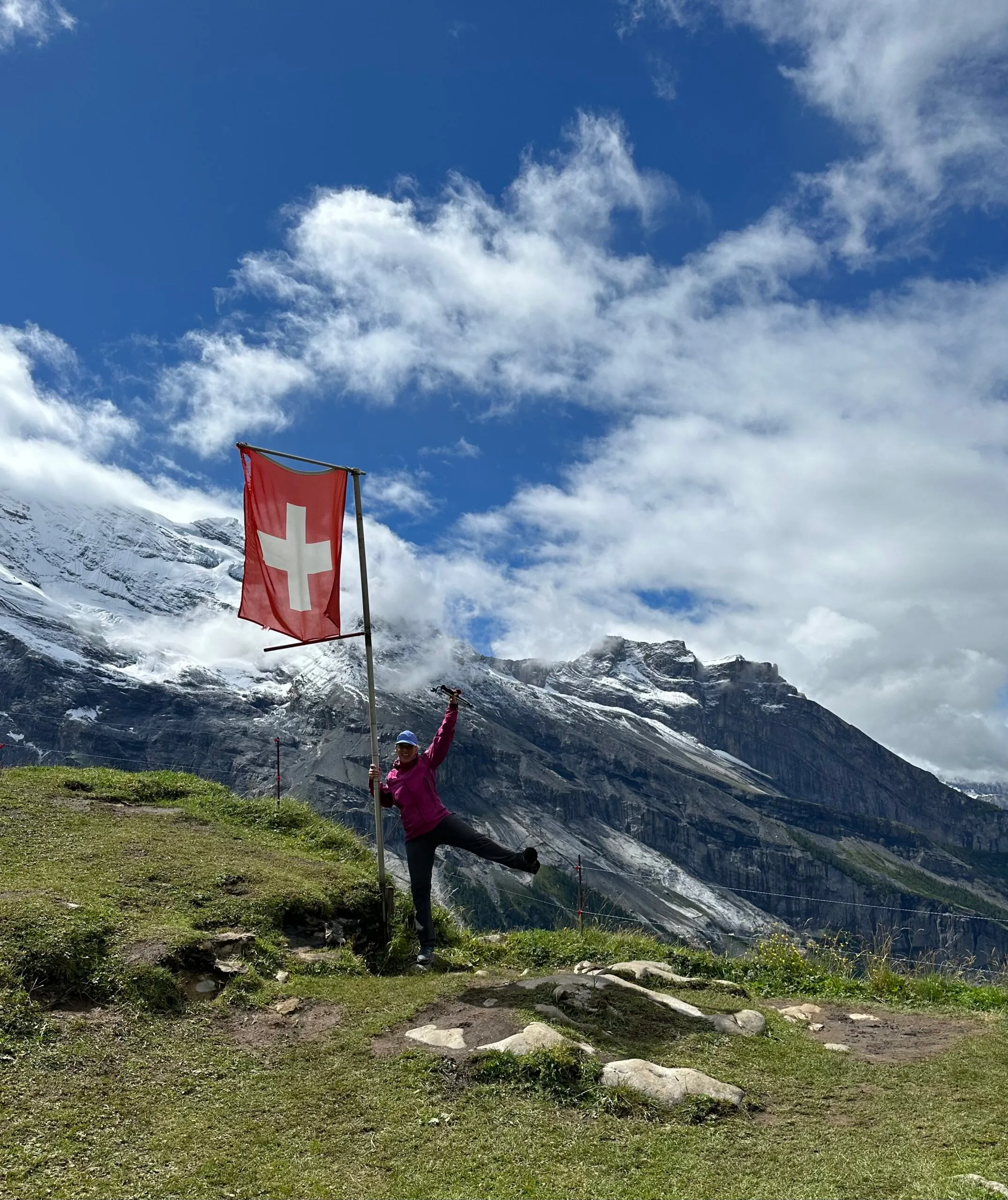 female traveler hiking on a village to village hiking tour in Alps region near Mont Blanc, Matterhorn, and Eiger