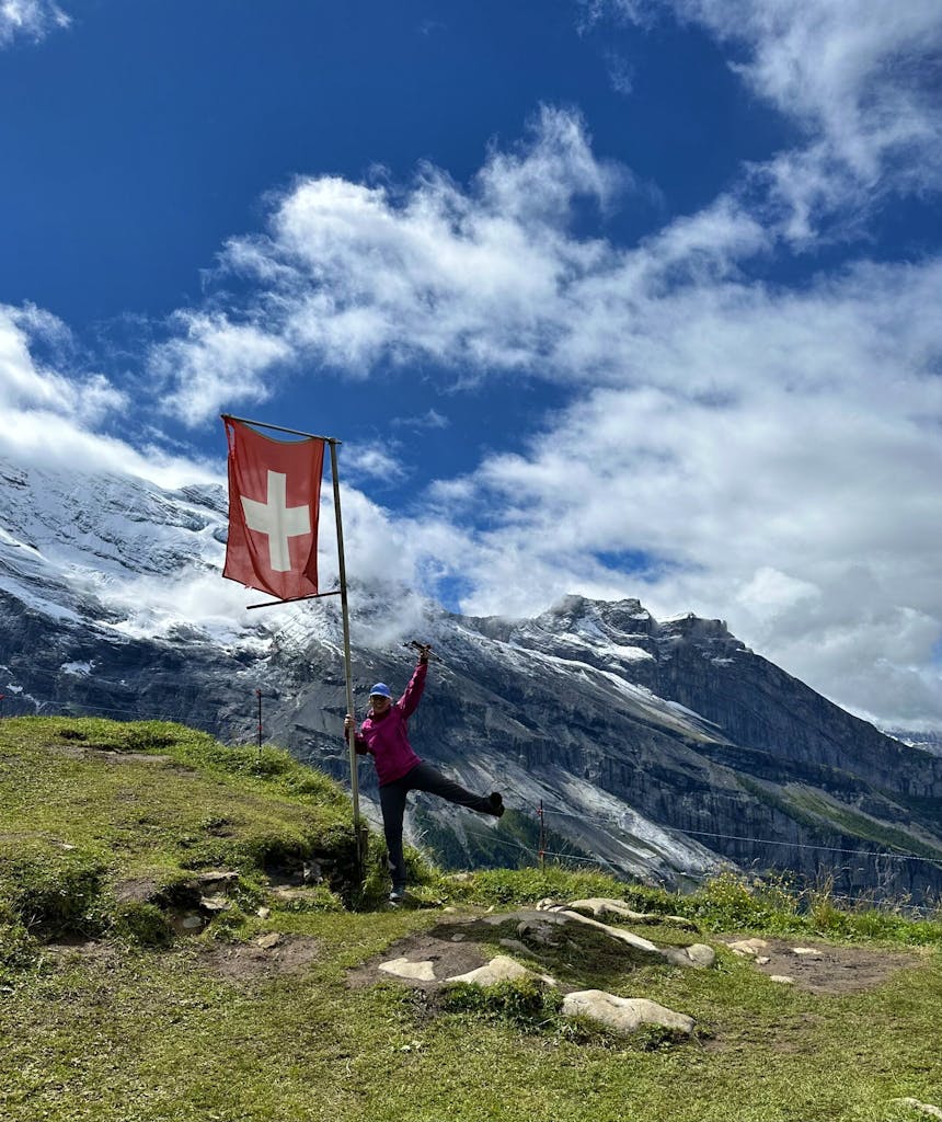 female traveler hiking on a village to village hiking tour in Alps region near Mont Blanc, Matterhorn, and Eiger