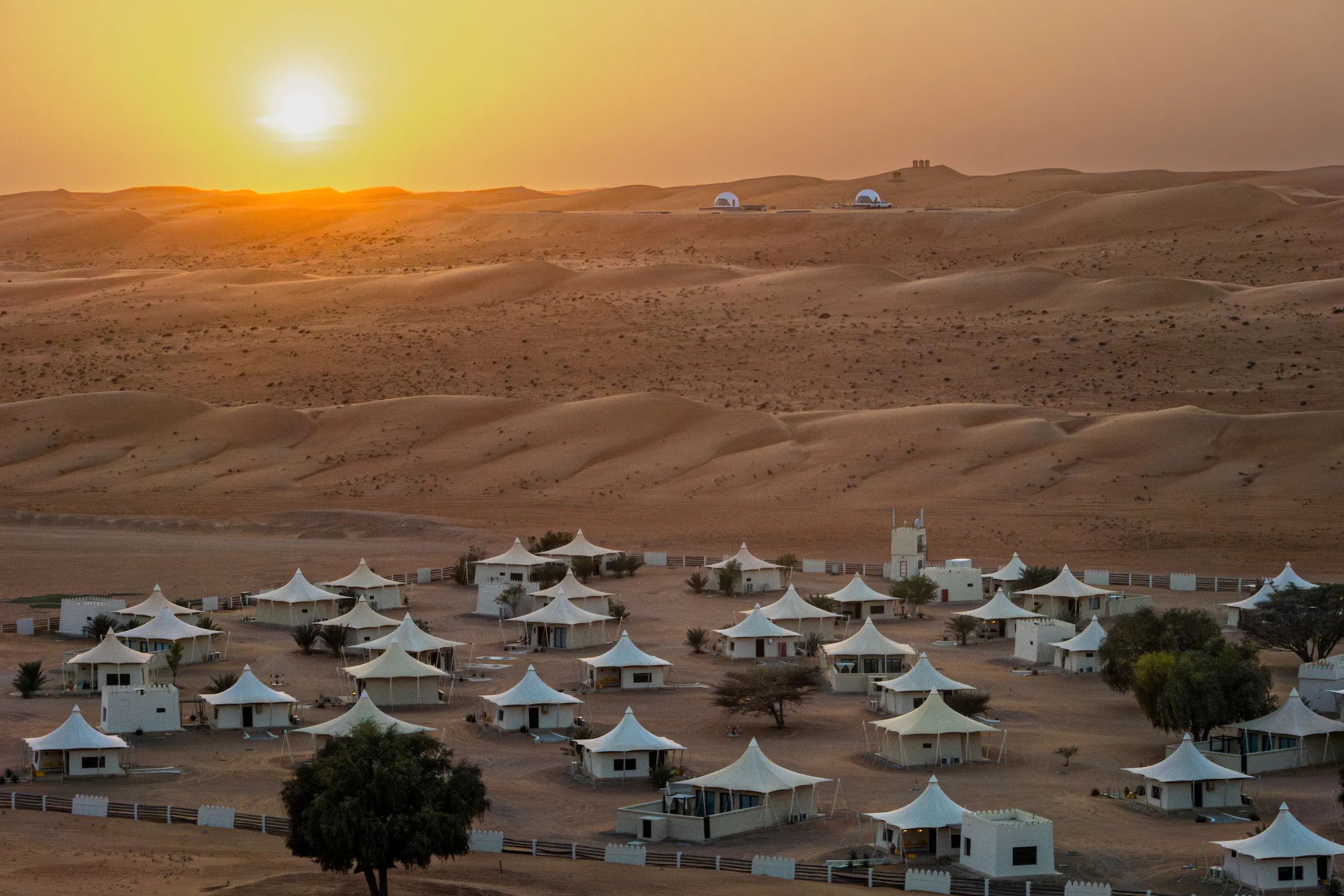 travelers encountering Bedouin tribes in the rolling dunes of the Wahiba Sands in Oman, Middle East