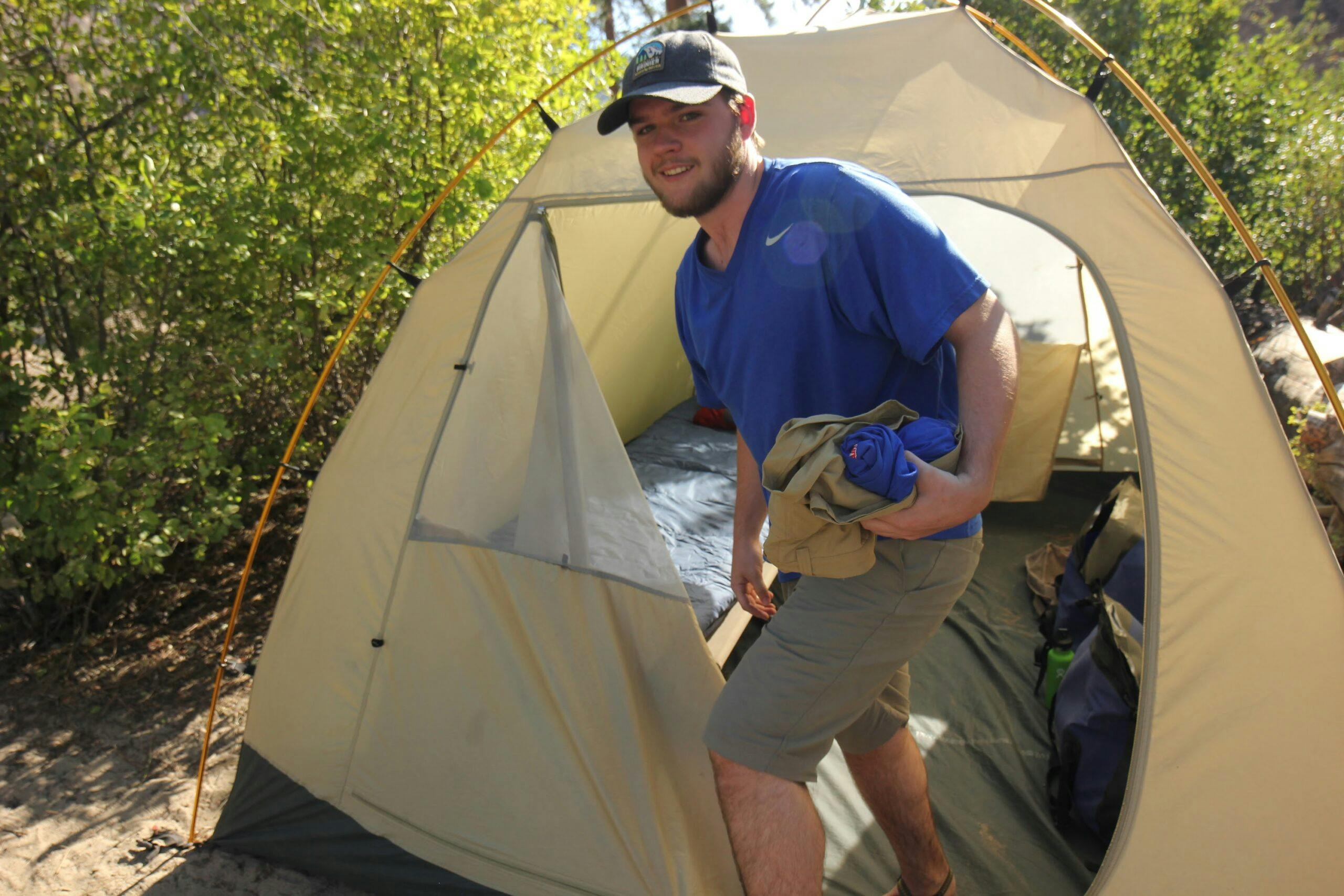 Young man and tent on the Middle Fork of the Salmon River with MT Sobek