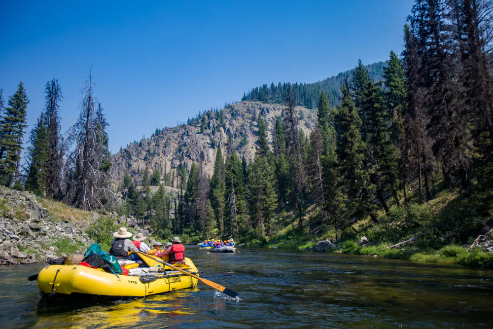 family rafting on a floatable kayak in the Middle Fork of the Salmon River in the summertime