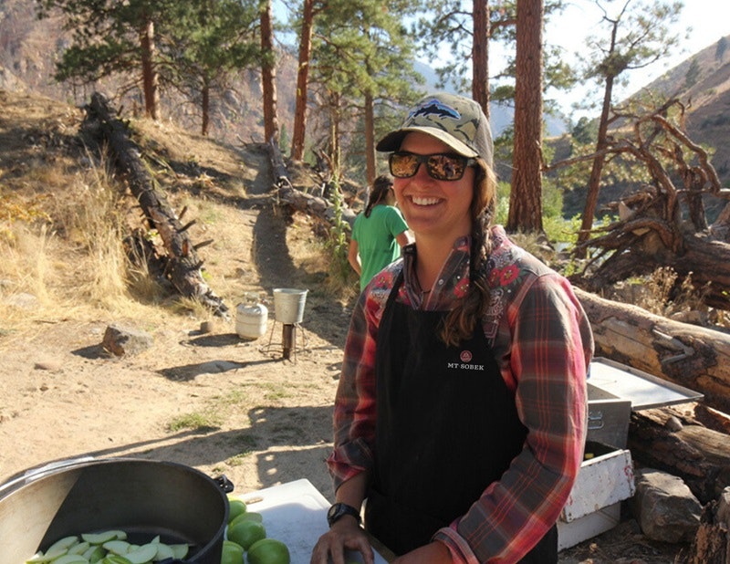 River guide prepares a freshly cooked meal on the Middle Fork of the Salmon in Idaho with MT Sobek