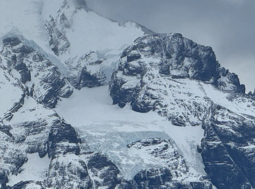 Diane traveling to Patagonia in the midst of snowy capped mountains
