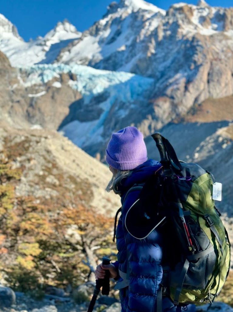 female traveler near Fitz Roy hiking trip in autumn time in Argentina