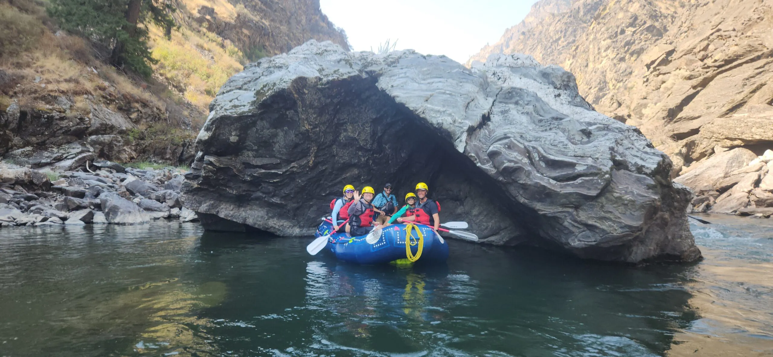 group on paddle boat in water with paddles in Idaho Middle Fork rafting trip
