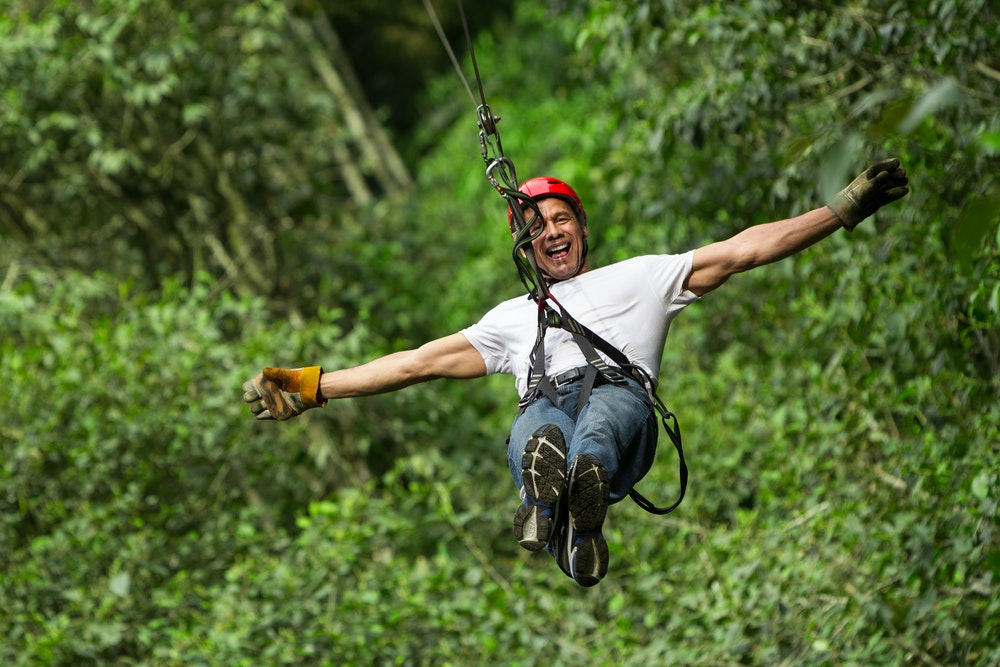 man ziplining in natural settings in Costa Rica Tortuguero National Park