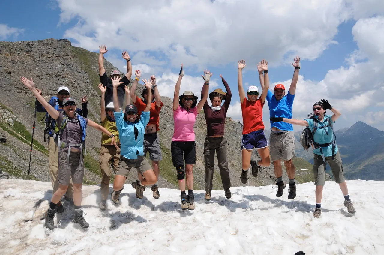 big group of travelers on hiking multi day trek in Alps region in Europe