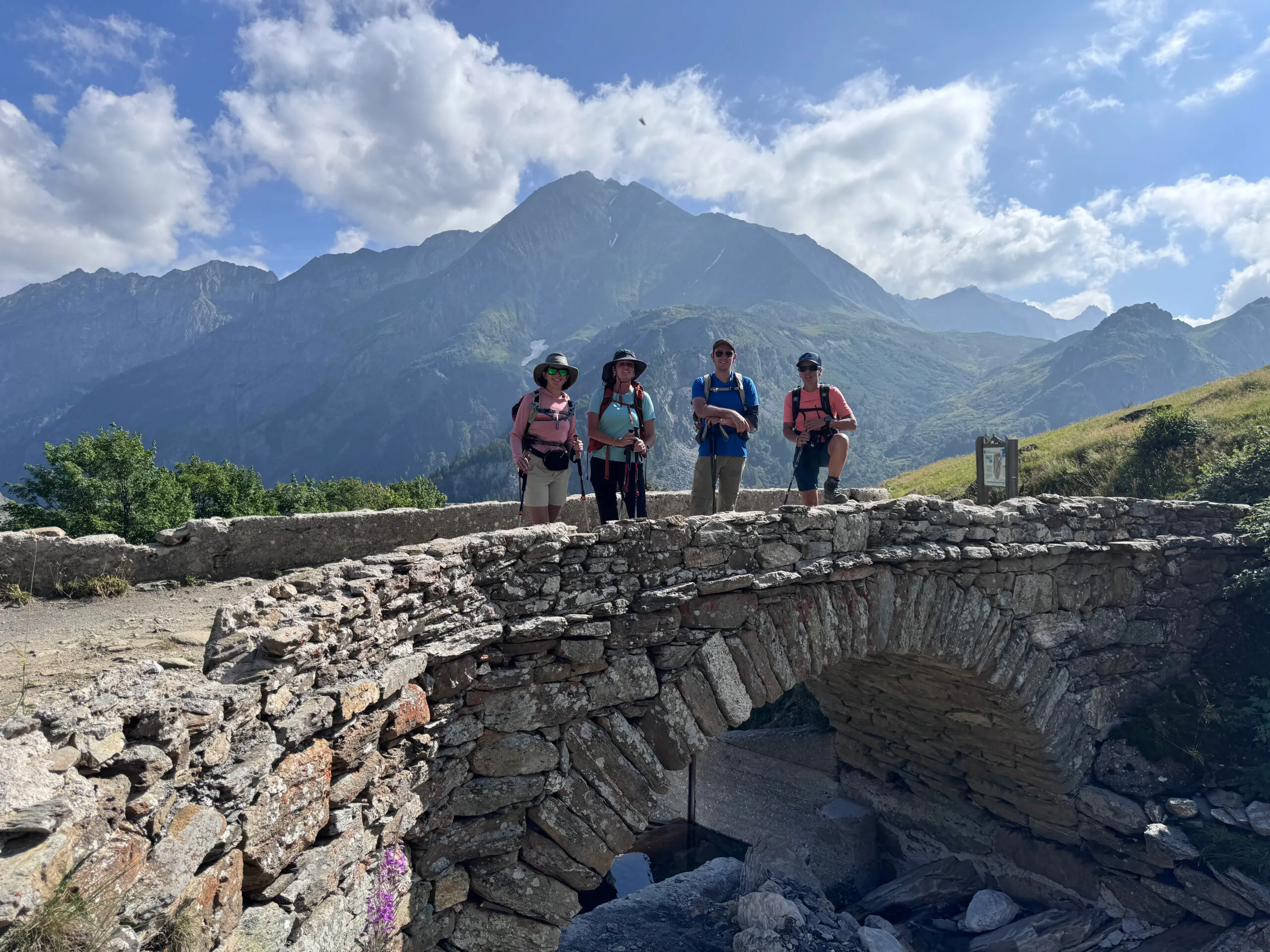 family of hikers near hiking trail in the Alps region in Europe