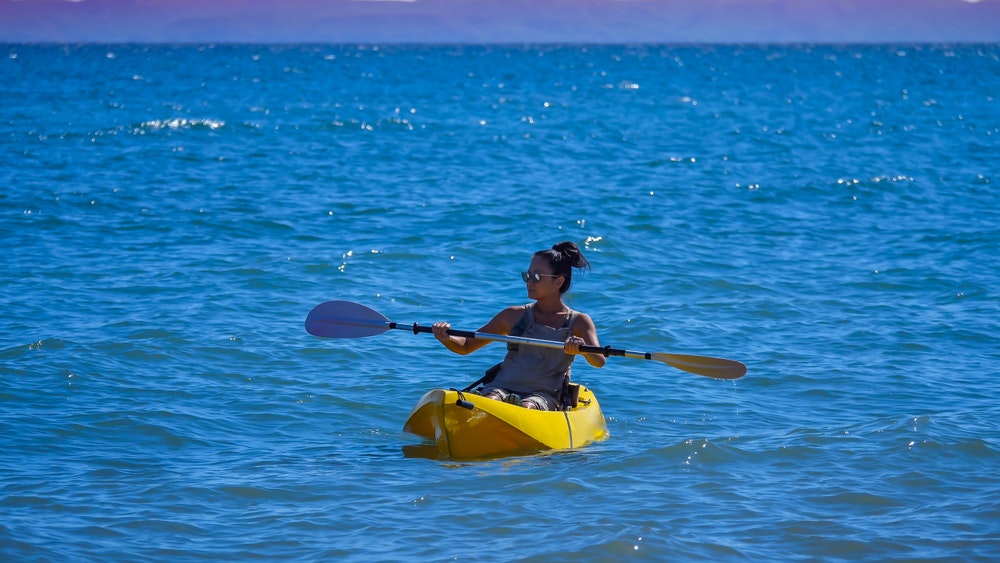 woman kayaking in Mexico's Baja, Sea of Cortez in the wintertime
