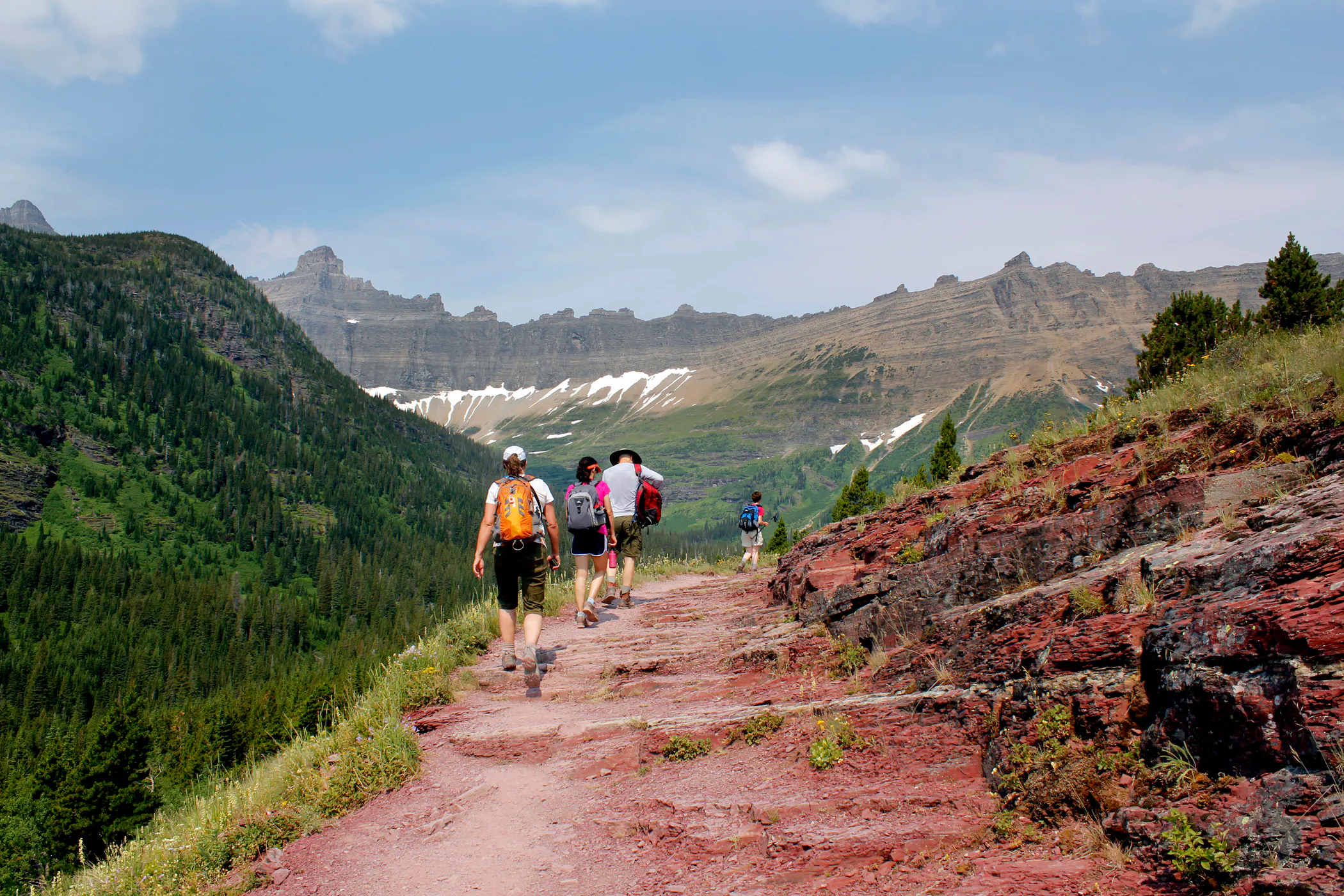 group of hikes on glacial hiking trail in iceberg mountain in Glacier National Park, Montana, North America