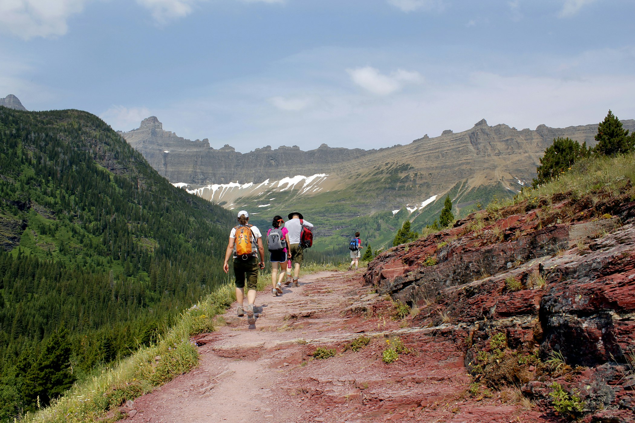 group of hikes on glacial hiking trail in iceberg mountain in Glacier National Park, Montana, North America