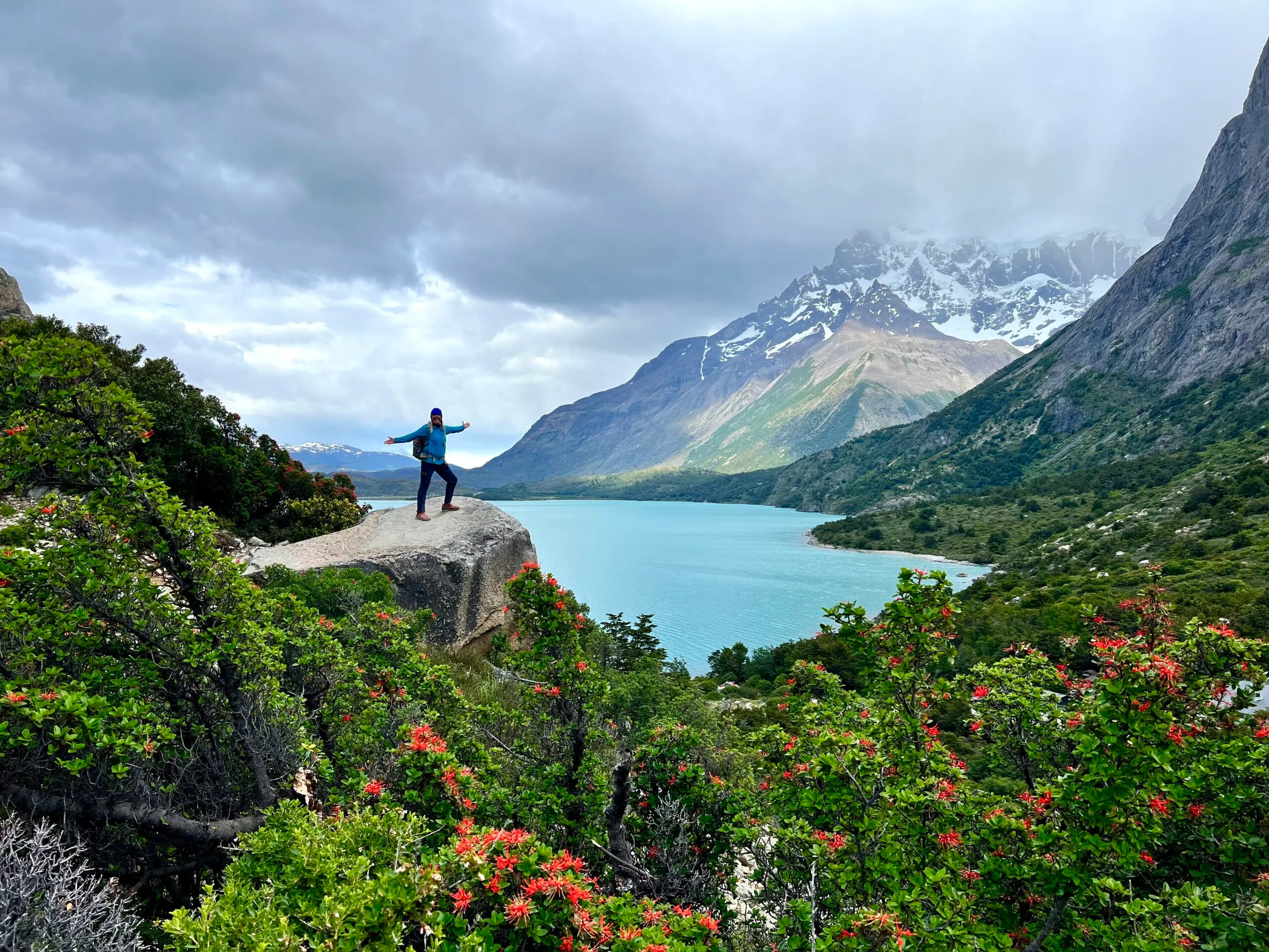 hiker on top of mountain near lake landscapes in Torres del Paine in Patagonia