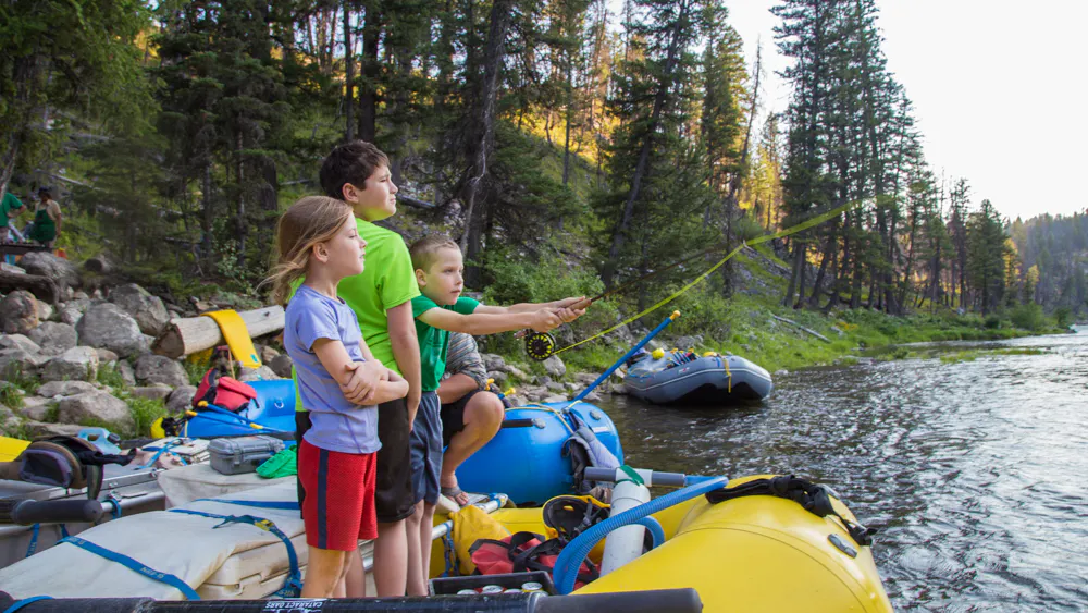 kids fly fishing near kayaks in Middle Fork of the Salmon River in Idaho