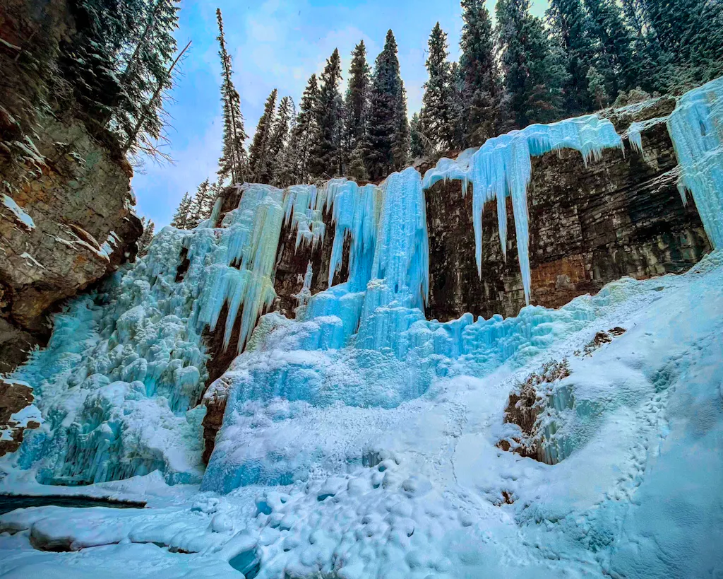 hiking trail to frozen waterfall in Johnston Canyon in wintertime in Canada Banff National Park