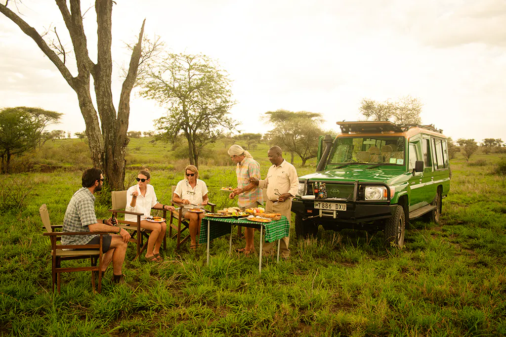 guides providing meals in tanzania safari