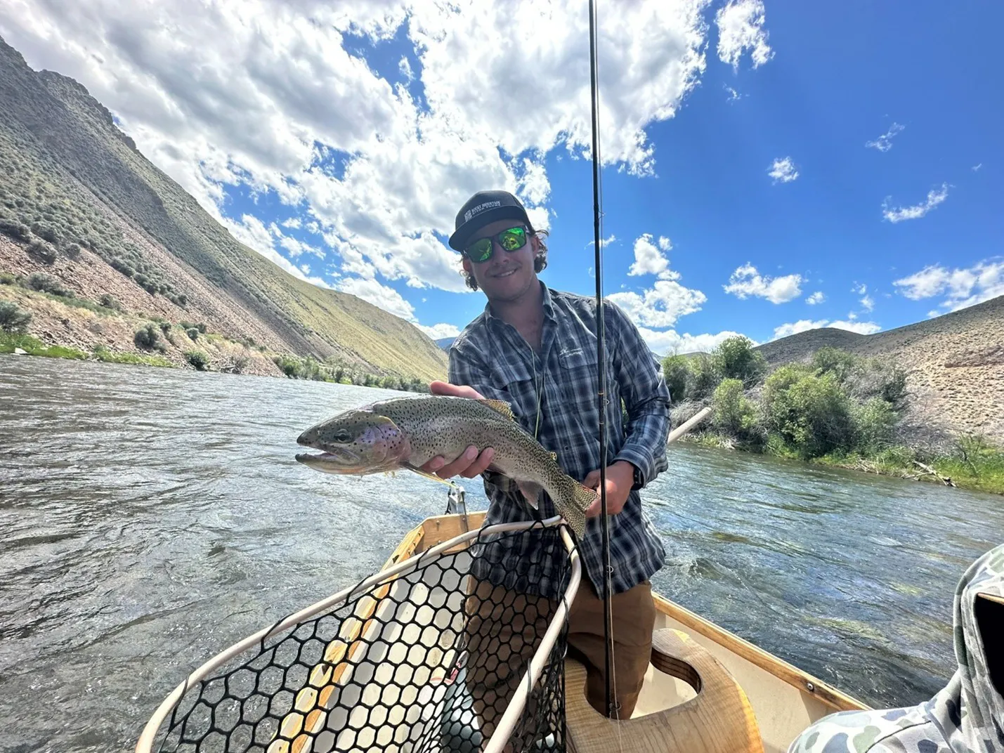 guide fly fishing for a trout on Middle Fork in Idaho