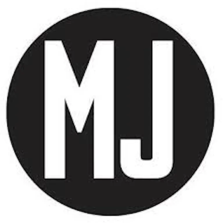 A black circle with the white capital letters “MJ” in the center, reminiscent of a stylish awards emblem.