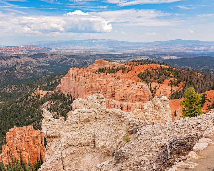 View of Bryce hoodoos in the foreground and the vast Grand Staircase-Escalante in the background