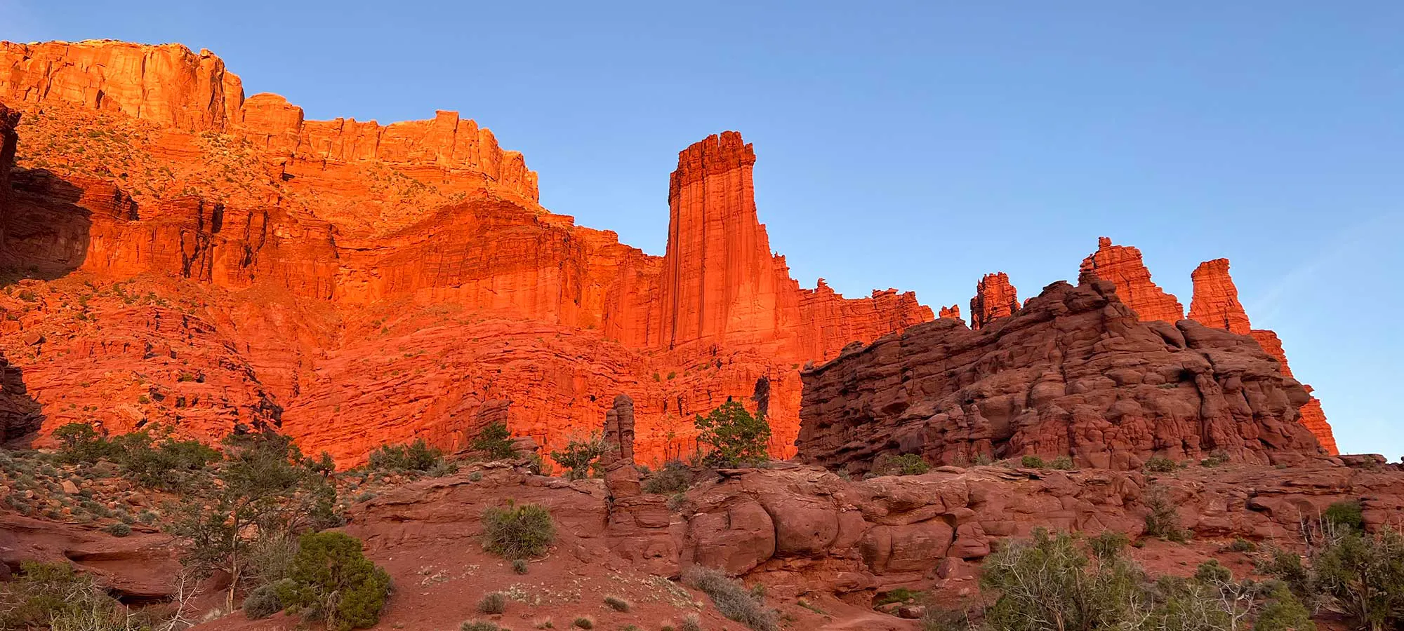 Fisher Towers at sunset with brilliant red colors lighting up their sheer cliffs, Utah