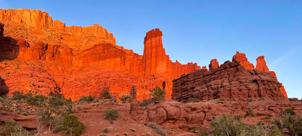 Fisher Towers at sunset with brilliant red colors lighting up their sheer cliffs, Utah