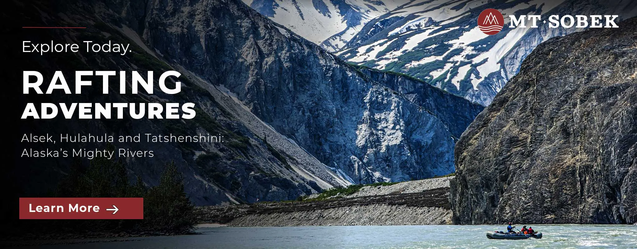 A small group enjoys river rafting in North America on a river surrounded by steep, rocky mountains with snow patches under a partly cloudy sky.